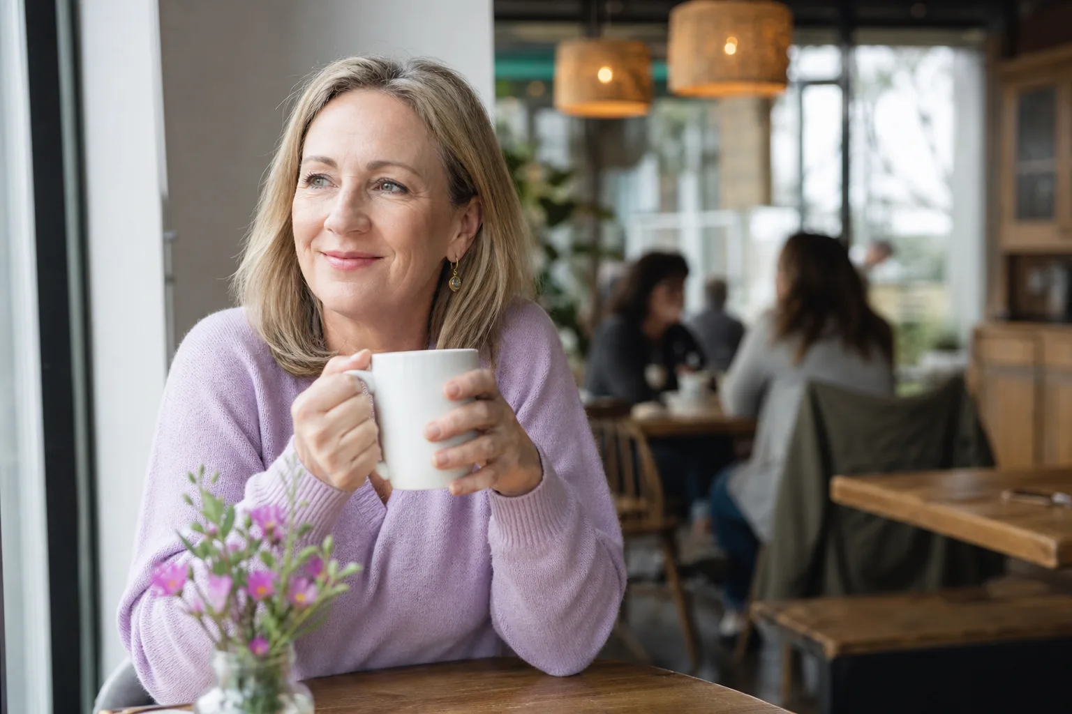 Woman over 50 enjoying a relaxed conversation over coffee in Wiltshire